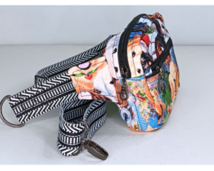 Handmade cotton belt bag with colorful dog print, front zipper pocket, and adjustable strap—fun, lightweight crossbody design.